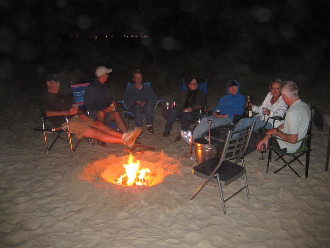 The Preserve at Oak Island home owners enjoy a night on the beach by a campfire. Oak Island Condos for Sale. Southport NC condos for sale.
